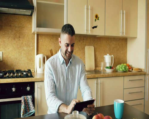 Pakistani man preparing a simple homemade lunch in a modern kitchen