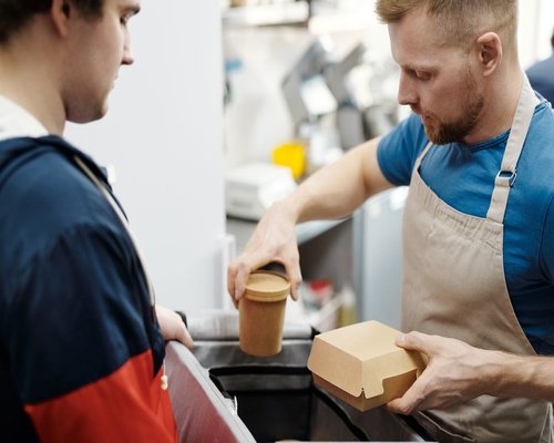 Adult man packing a practical lunch before going to work